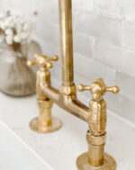 Unlacquered brass bridge kitchen faucet