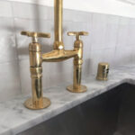 Unlacquered brass bridge kitchen faucet