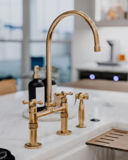 Unlacquered brass bridge kitchen faucet